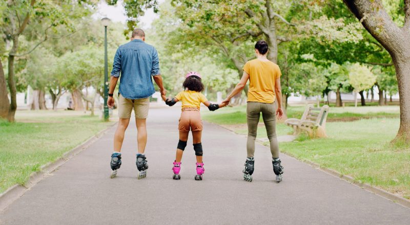 Family, park and holding hands to rollerskate with girl child with care, learning and support. Inte.