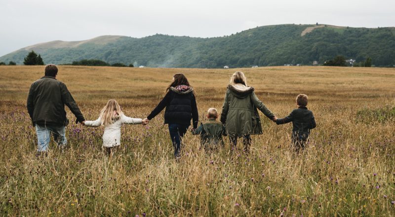 rear-view-of-family-holding-hands-walking